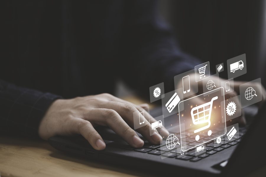 Shopper using computer laptop input order with trolley credit card delivery truck online shopping ecommerce technology concept copy