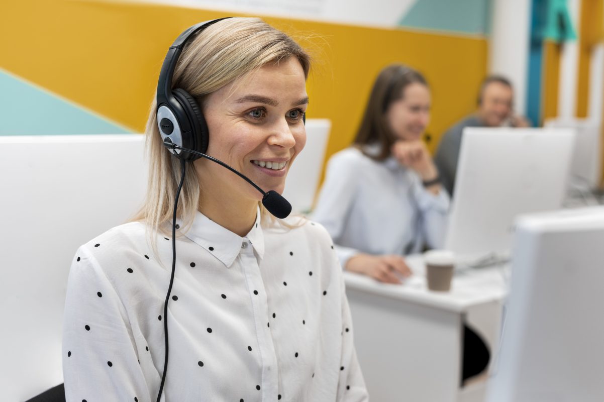 Blond woman working call center with headphones computer 1 copy