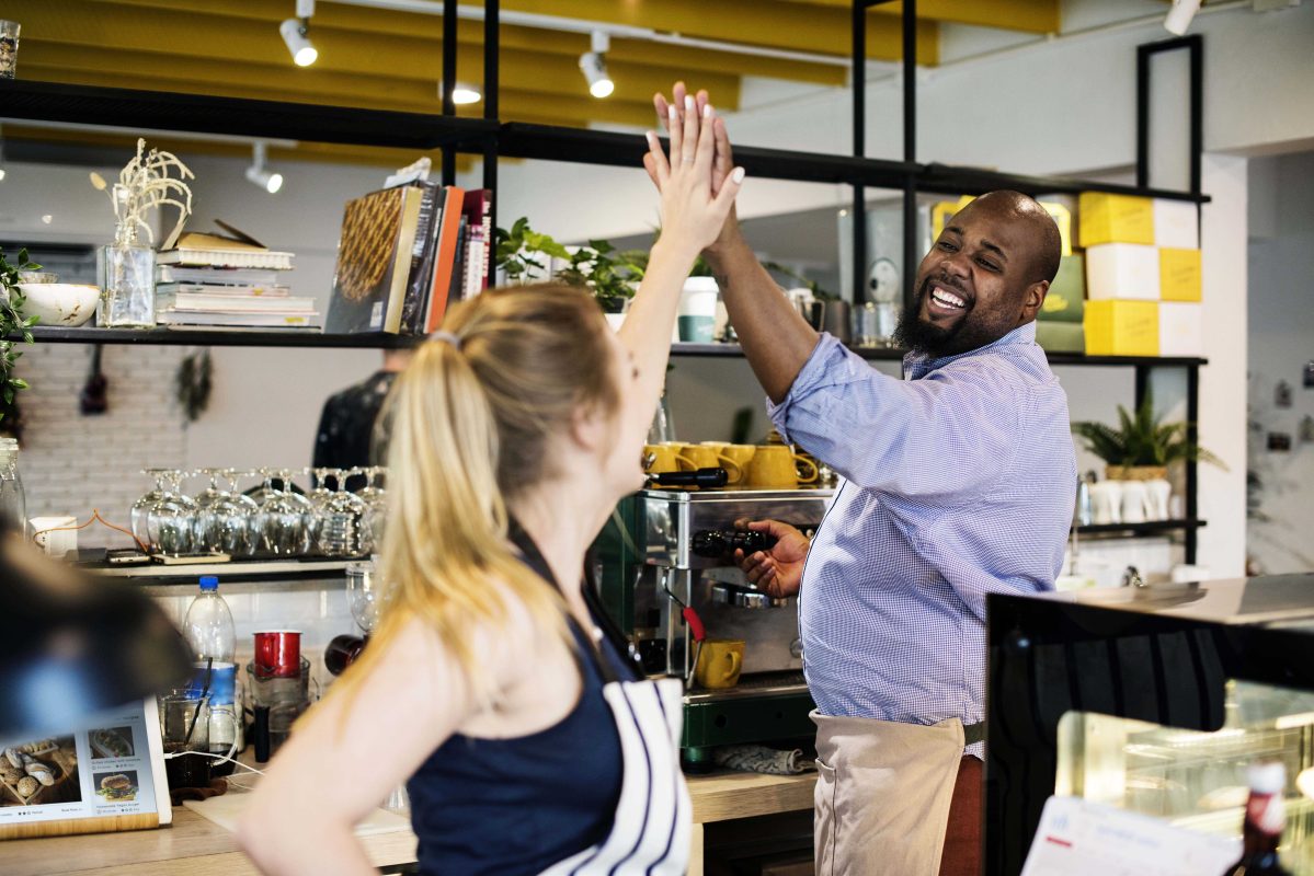Colleagues give high five each other copy
