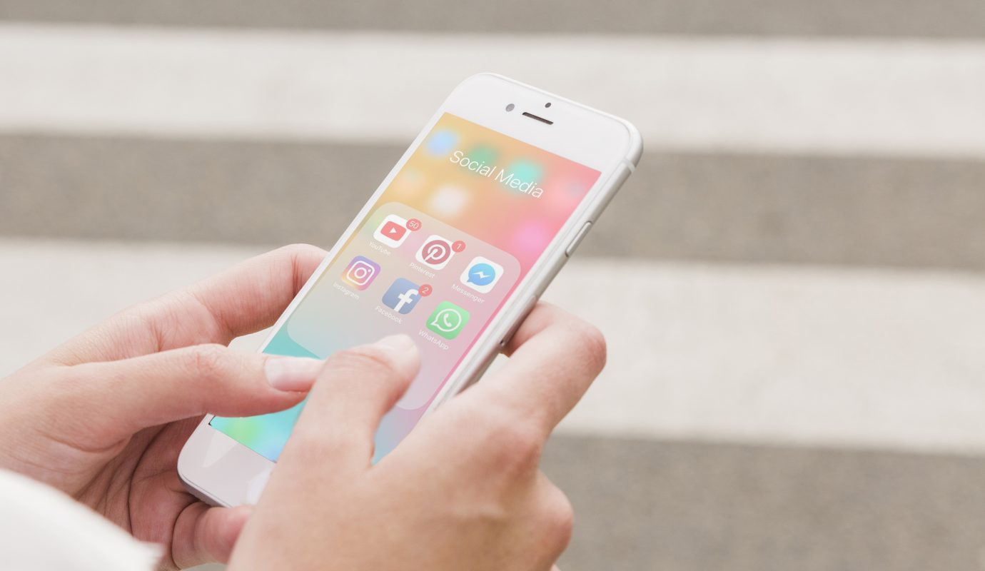 Person s hand holding cellphone with social media notifications screen copy