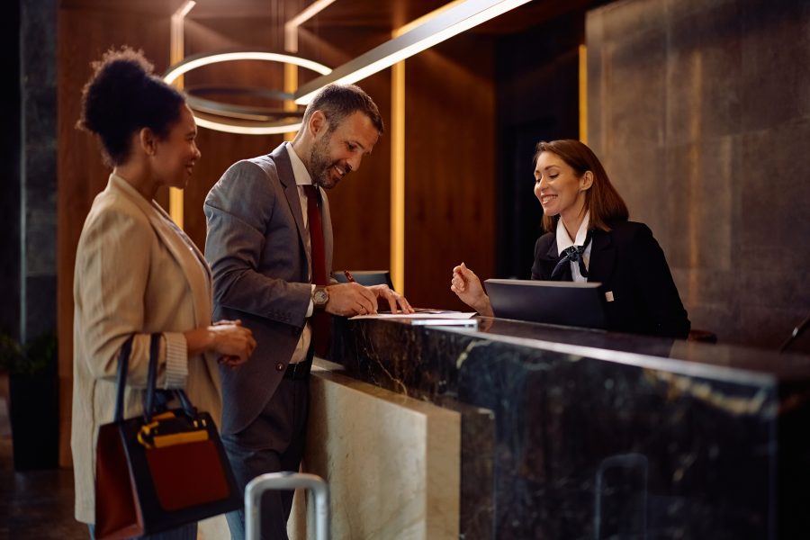 Happy business couple checking hotel