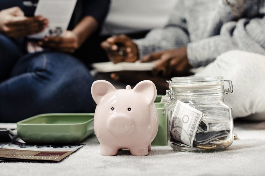 Mother teaching her daughter about savings copy