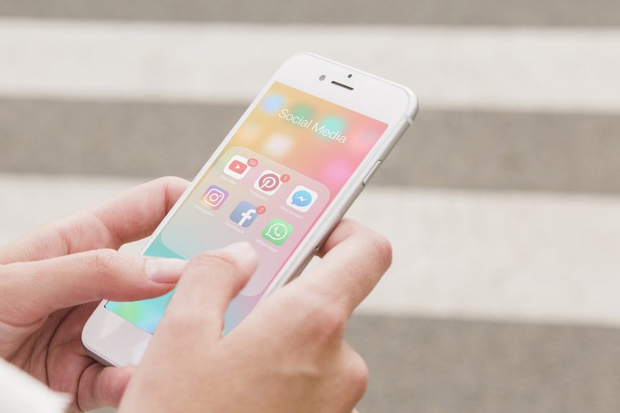 Person s hand holding cellphone with social media notifications screen copy