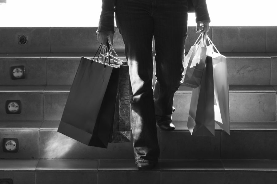 Person walking stairs with shopping bags copy