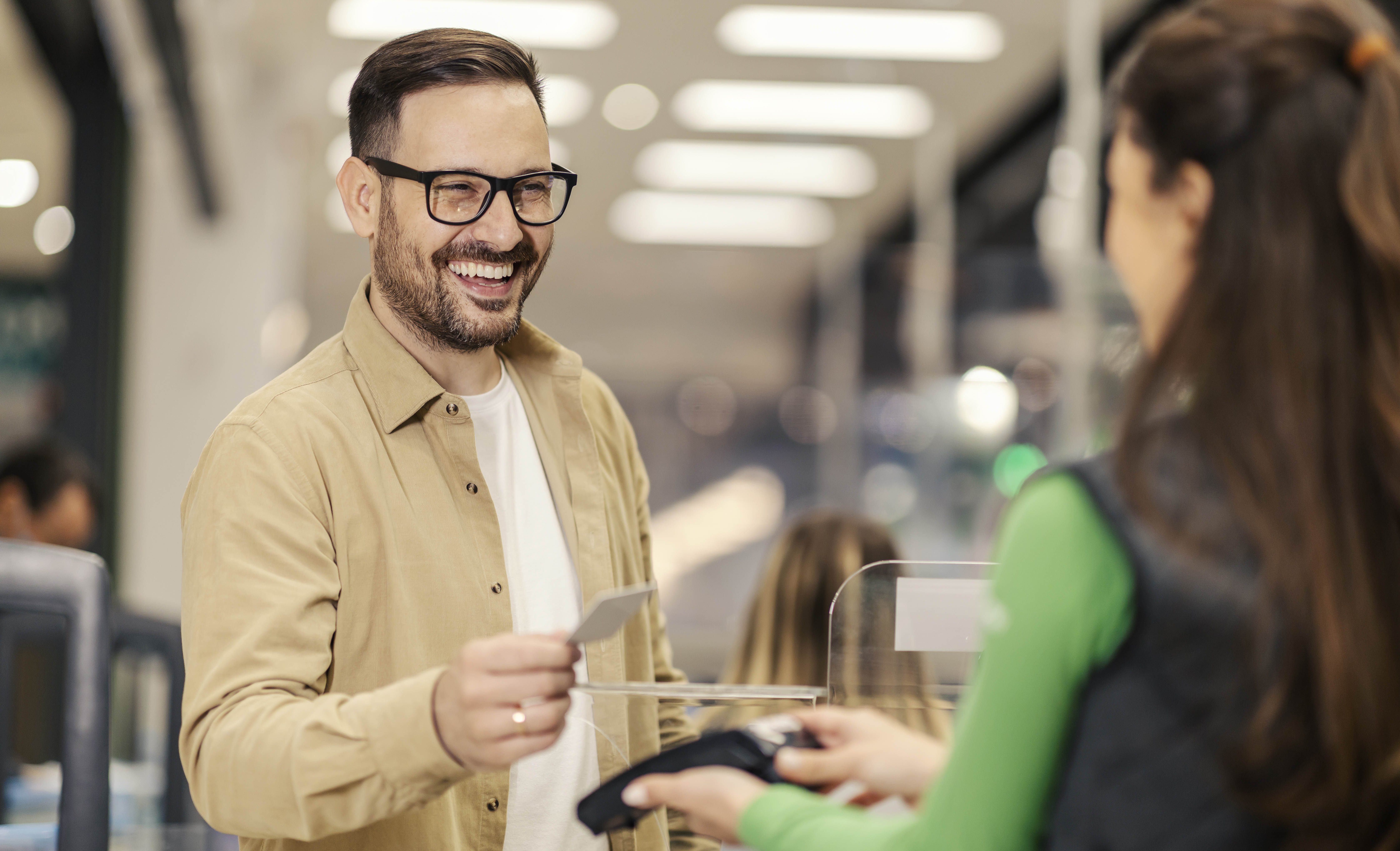 Happy man checkout is paying with credit card pos terminal copy