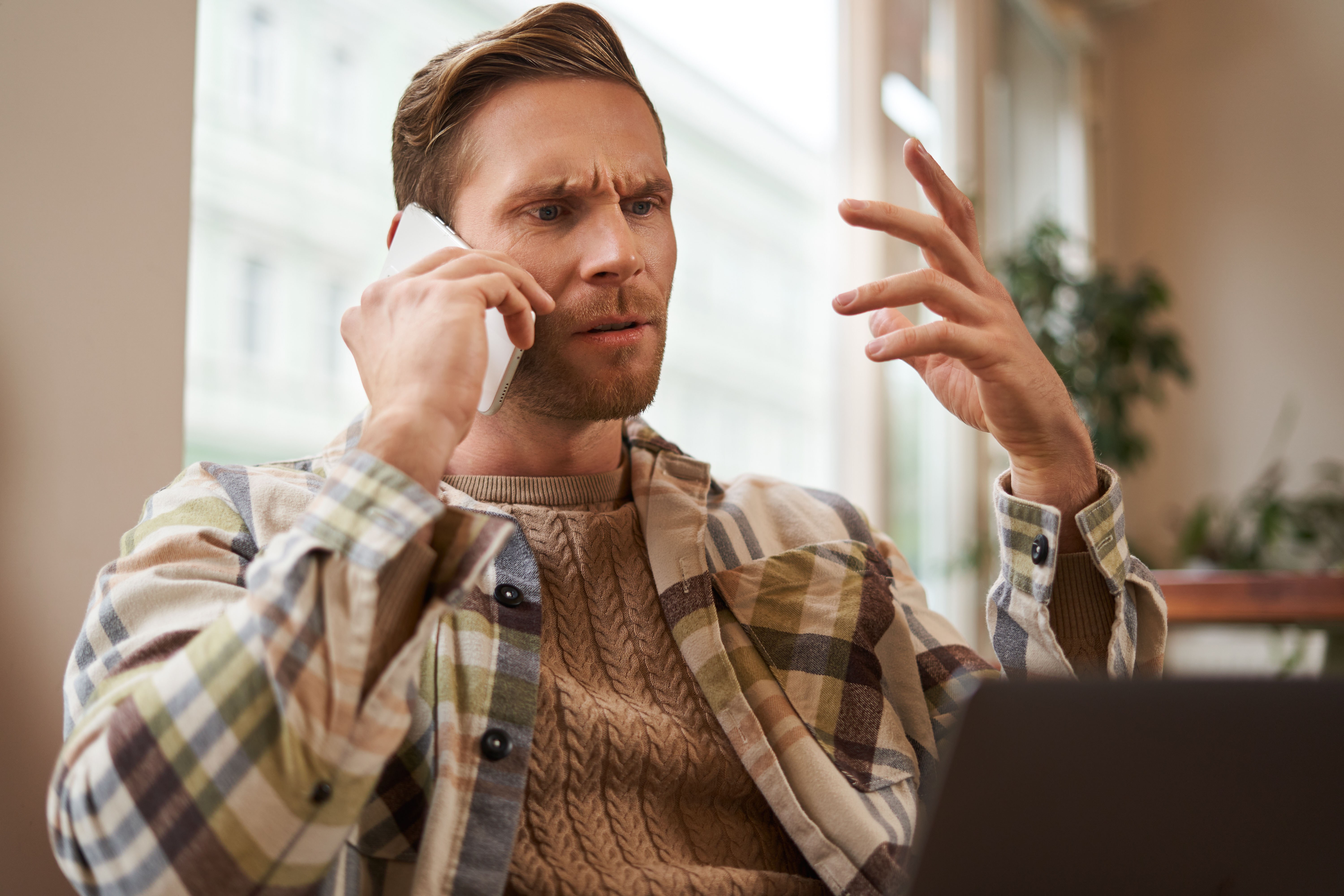 Portrait confused man arguing with someone phone businessman discuss project looking copy