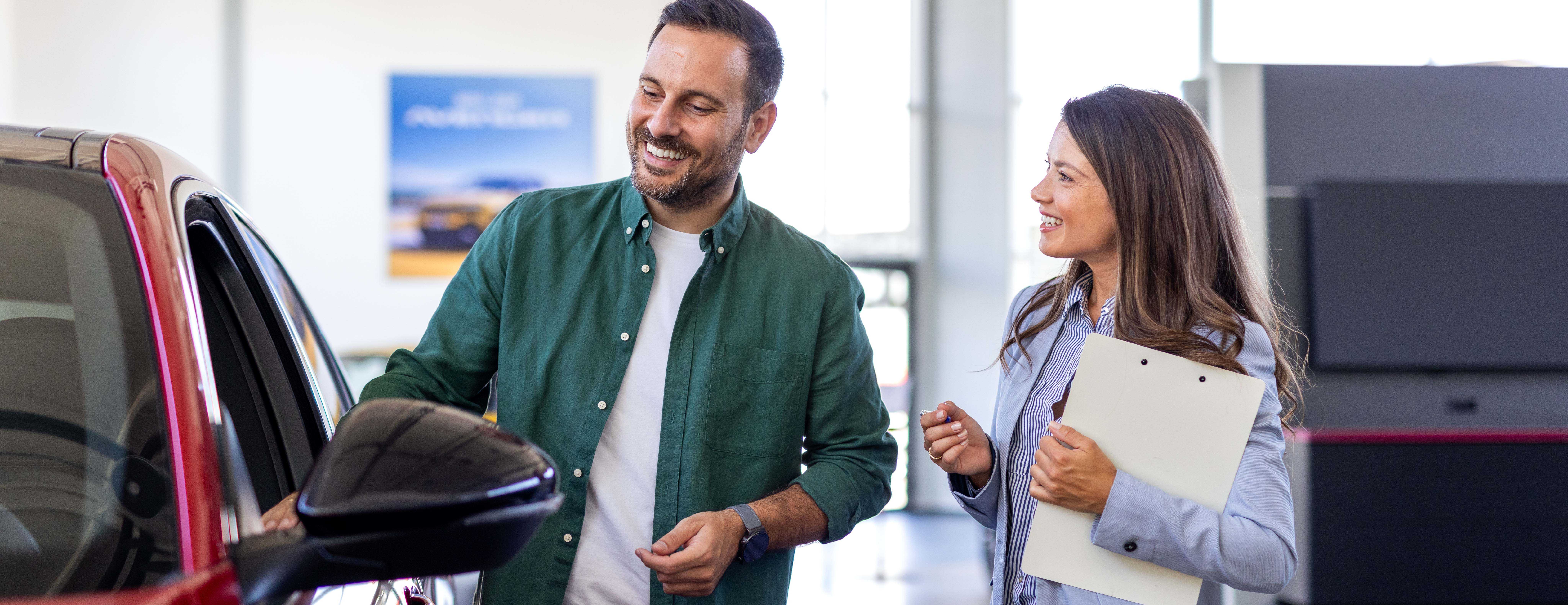 Young woman consultant show room talking with client professional salesperson selling cars dealership buyer copy